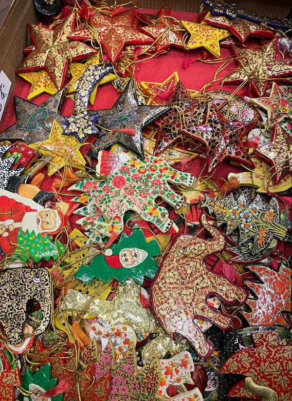 Collection of decorative Christmas ornaments including stars and animals on a red background.